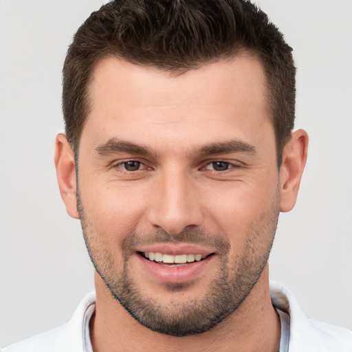 Joyful white young-adult male with short  brown hair and brown eyes