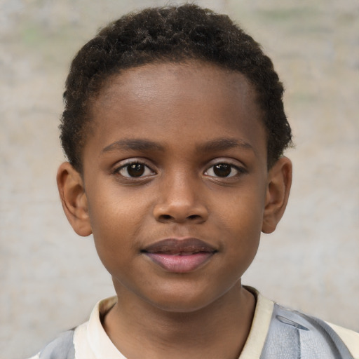 Joyful black child male with short  brown hair and brown eyes