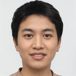 Joyful asian young-adult male with short  black hair and brown eyes