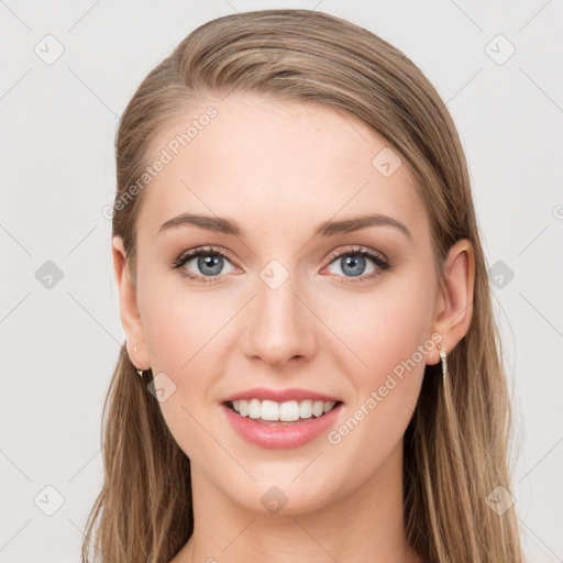 Joyful white young-adult female with long  brown hair and blue eyes