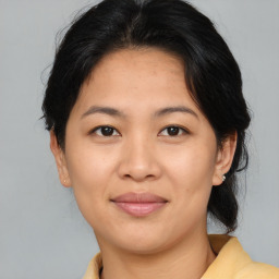 Joyful asian young-adult female with medium  brown hair and brown eyes