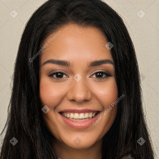 Joyful latino young-adult female with long  brown hair and brown eyes