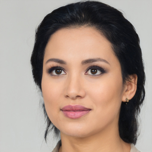 Joyful latino young-adult female with medium  black hair and brown eyes