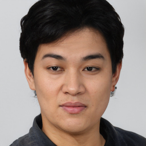 Joyful asian young-adult male with short  black hair and brown eyes