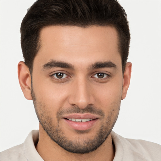 Joyful white young-adult male with short  brown hair and brown eyes