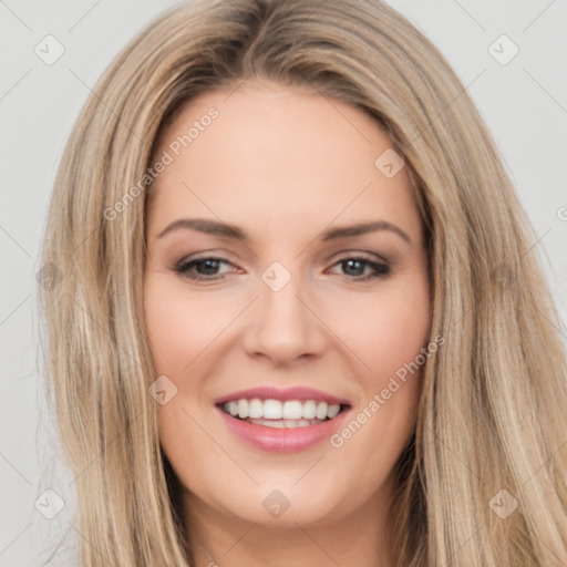 Joyful white young-adult female with long  brown hair and brown eyes