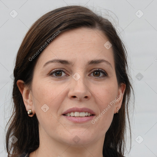 Joyful white adult female with long  brown hair and grey eyes