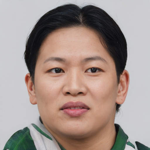 Joyful asian young-adult female with short  brown hair and brown eyes
