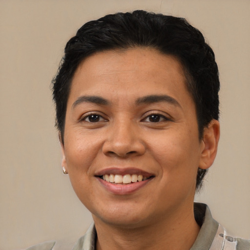 Joyful latino young-adult female with short  black hair and brown eyes