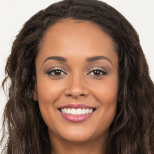 Joyful latino young-adult female with long  brown hair and brown eyes