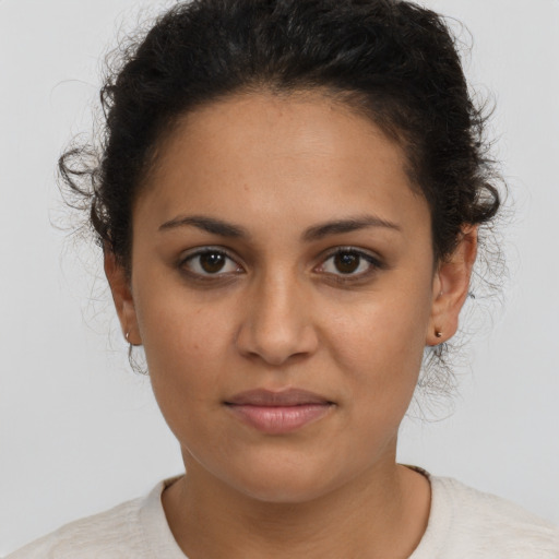 Joyful latino young-adult female with short  brown hair and brown eyes