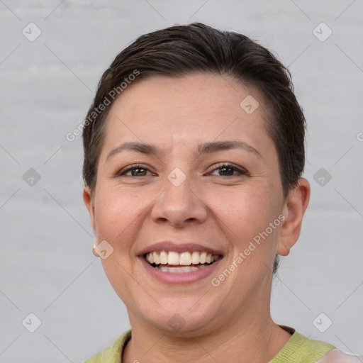 Joyful white adult female with short  brown hair and brown eyes