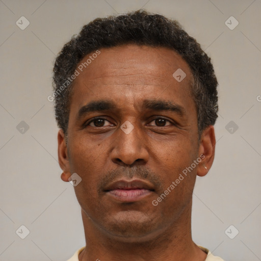 Neutral latino adult male with short  black hair and brown eyes