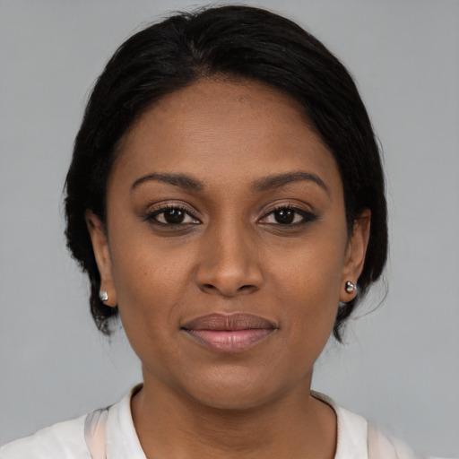 Joyful black young-adult female with medium  brown hair and brown eyes