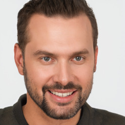 Joyful white young-adult male with short  brown hair and brown eyes