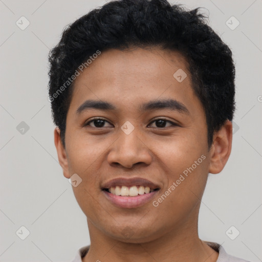 Joyful latino young-adult male with short  black hair and brown eyes