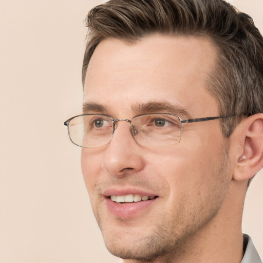 Joyful white adult male with short  brown hair and grey eyes