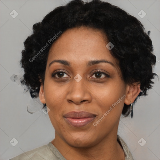 Joyful black adult female with short  black hair and brown eyes