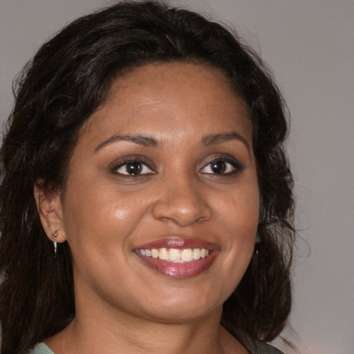 Joyful black young-adult female with medium  brown hair and brown eyes