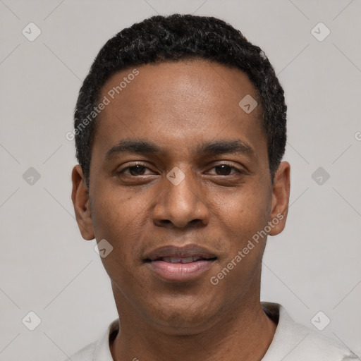 Joyful black young-adult male with short  black hair and brown eyes