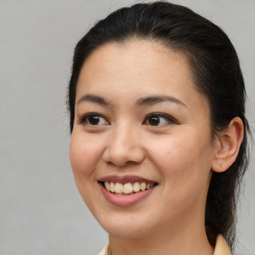 Joyful latino young-adult female with medium  brown hair and brown eyes