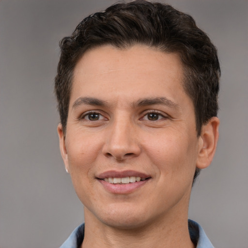 Joyful white adult male with short  brown hair and brown eyes