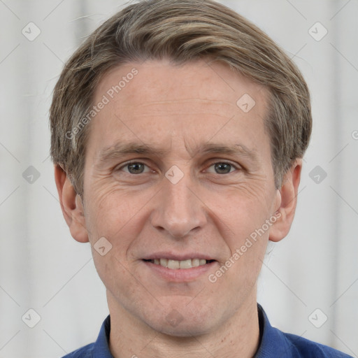 Joyful white adult male with short  brown hair and grey eyes