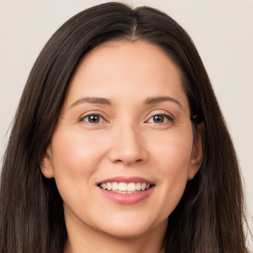 Joyful white young-adult female with long  brown hair and brown eyes