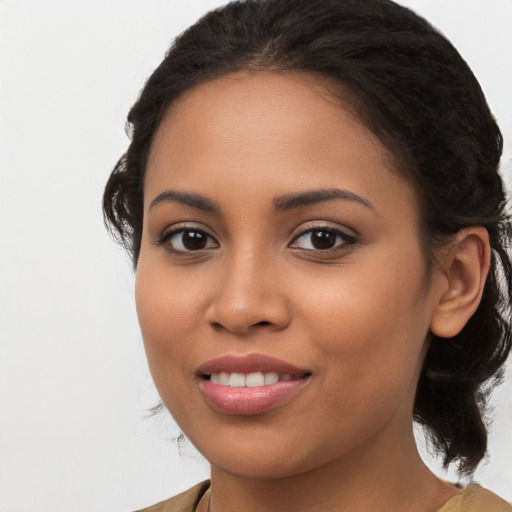 Joyful latino young-adult female with long  brown hair and brown eyes