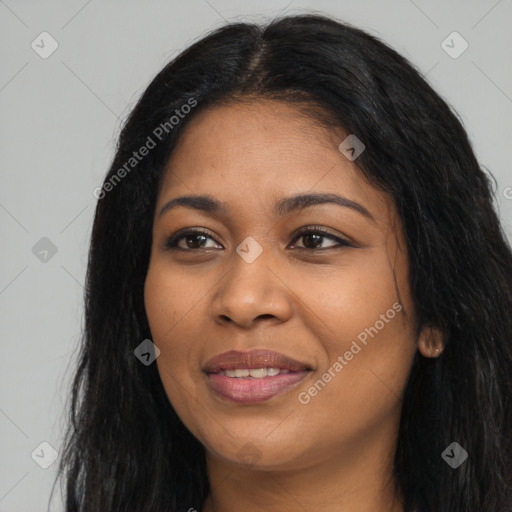 Joyful black young-adult female with long  black hair and brown eyes