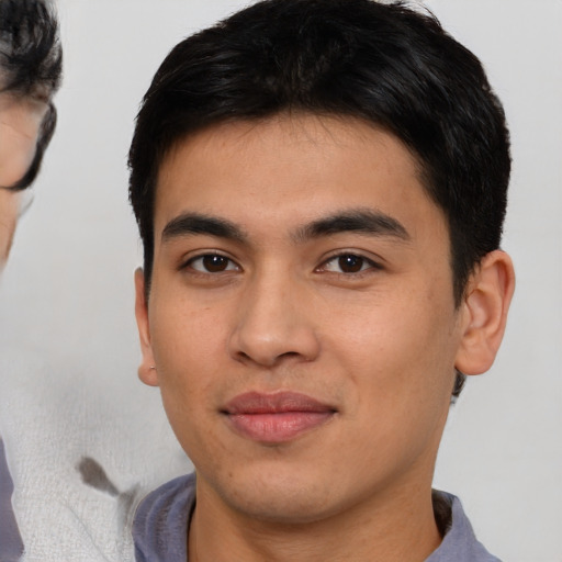 Joyful asian young-adult male with short  brown hair and brown eyes