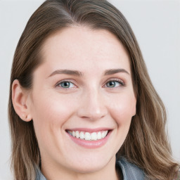 Joyful white young-adult female with long  brown hair and blue eyes