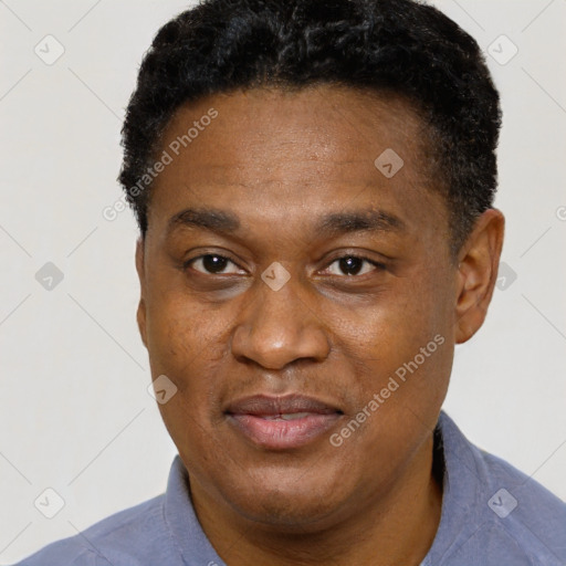 Joyful black adult male with short  black hair and brown eyes