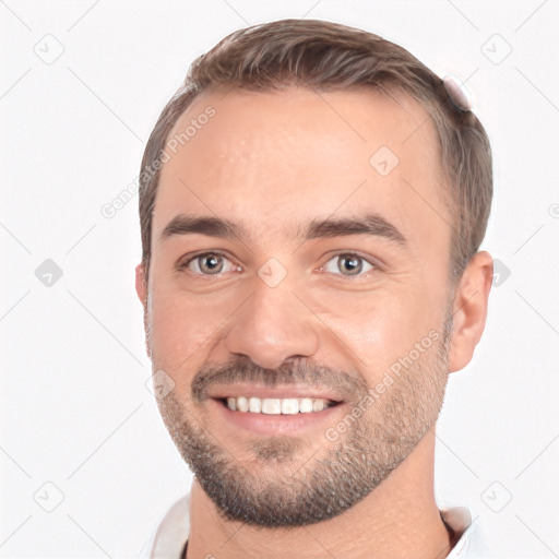 Joyful white young-adult male with short  brown hair and brown eyes