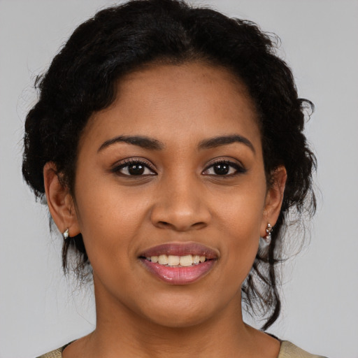 Joyful latino young-adult female with medium  brown hair and brown eyes