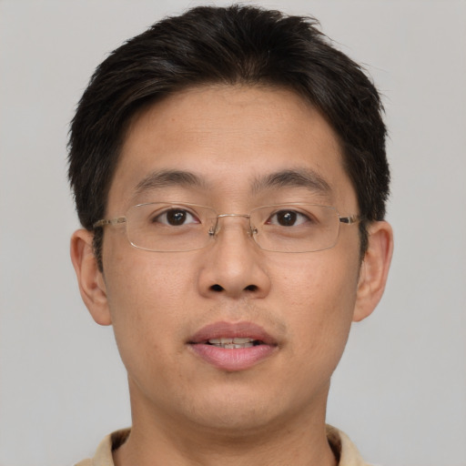 Joyful asian young-adult male with short  brown hair and brown eyes