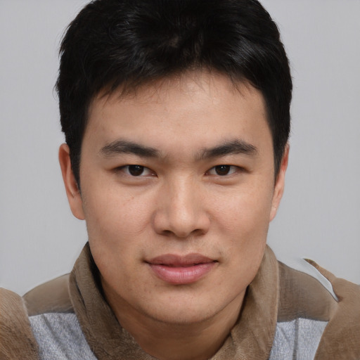 Joyful asian young-adult male with short  brown hair and brown eyes