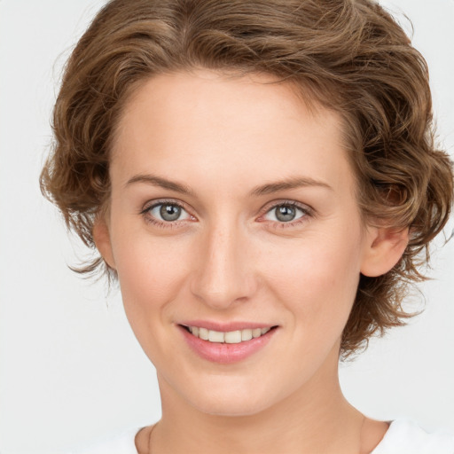 Joyful white young-adult female with medium  brown hair and green eyes