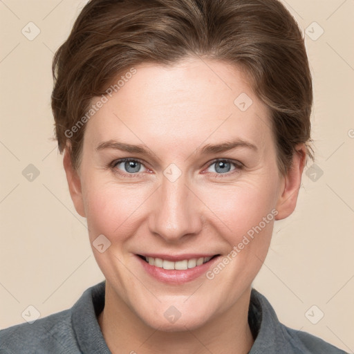 Joyful white young-adult female with short  brown hair and grey eyes