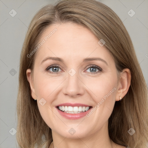 Joyful white adult female with long  brown hair and grey eyes