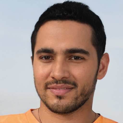 Joyful latino young-adult male with short  black hair and brown eyes