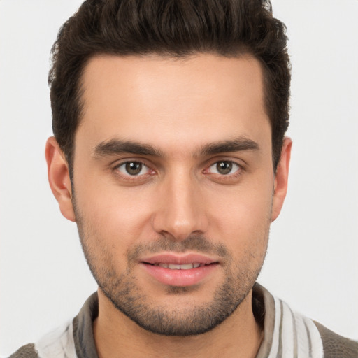 Joyful white young-adult male with short  brown hair and brown eyes