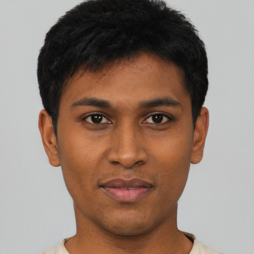 Joyful latino young-adult male with short  black hair and brown eyes