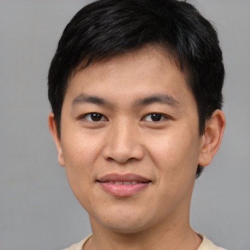 Joyful asian young-adult male with short  brown hair and brown eyes