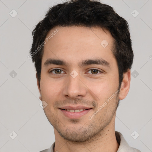 Joyful white young-adult male with short  black hair and brown eyes