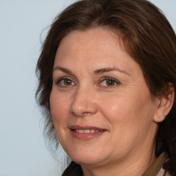 Joyful white adult female with medium  brown hair and brown eyes