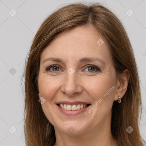 Joyful white adult female with long  brown hair and grey eyes