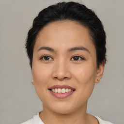 Joyful asian young-adult female with short  brown hair and brown eyes