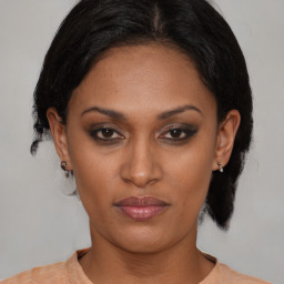 Joyful black young-adult female with medium  black hair and brown eyes