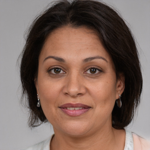 Joyful white adult female with medium  brown hair and brown eyes